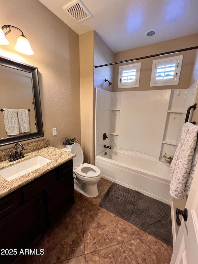 bathroom featuring bathing tub / shower combination, visible vents, toilet, vanity, and tile patterned floors