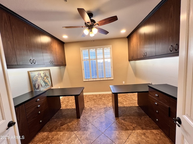 office featuring built in desk, a ceiling fan, and baseboards