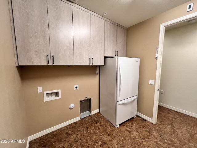 washroom featuring cabinet space, baseboards, gas dryer hookup, hookup for a washing machine, and hookup for an electric dryer