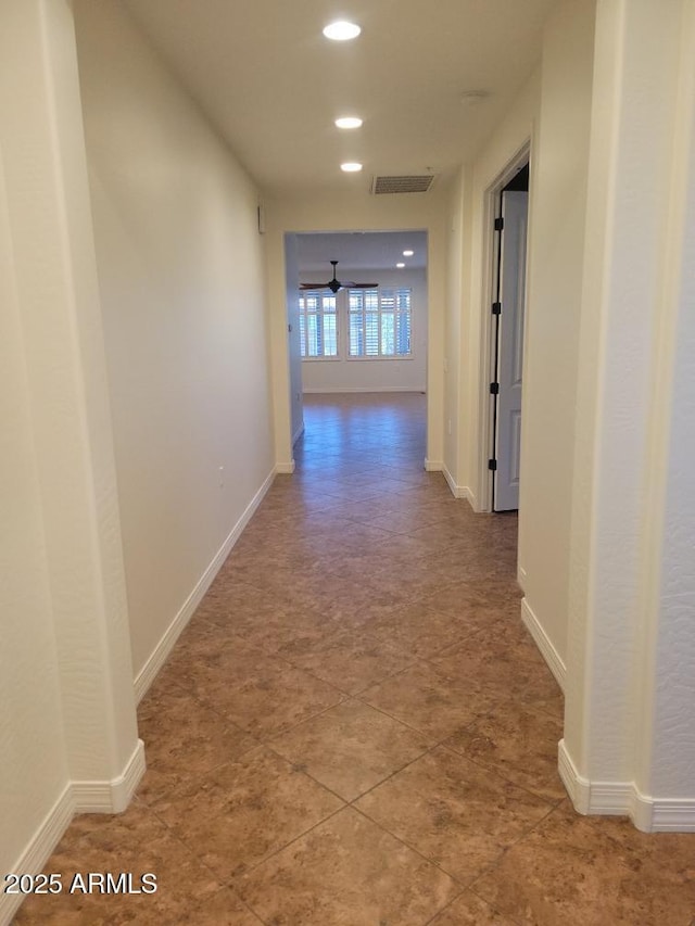 corridor featuring recessed lighting, visible vents, and baseboards