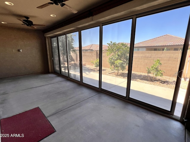 interior space with ceiling fan