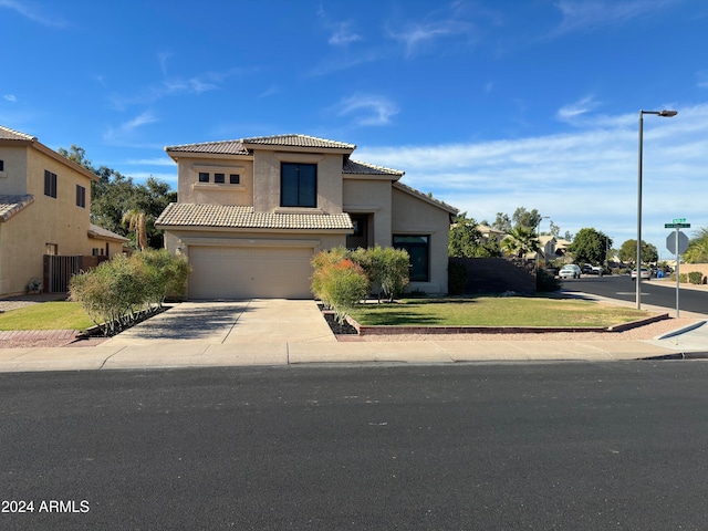 mediterranean / spanish-style home with a garage and a front yard