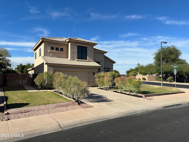 view of front of property with a garage and a front yard