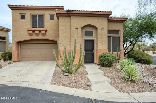 mediterranean / spanish house with a garage