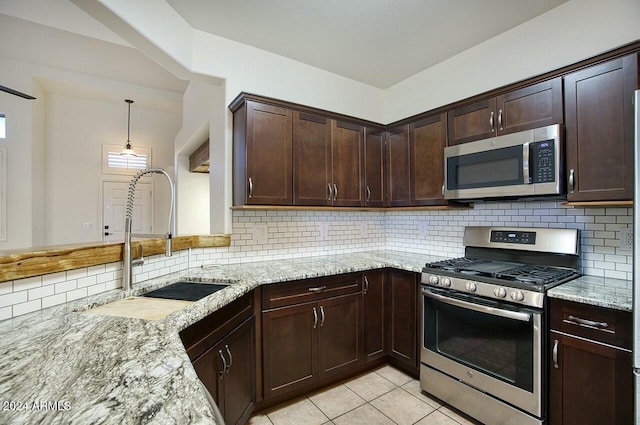 kitchen with decorative backsplash, sink, light tile patterned floors, and stainless steel appliances