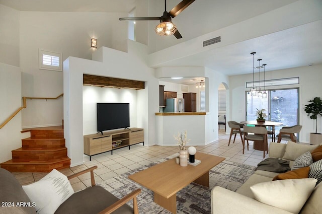 living room with ceiling fan, a healthy amount of sunlight, and light tile patterned flooring