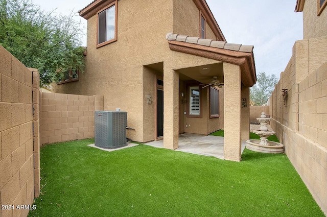 rear view of house featuring a lawn, a patio area, and central air condition unit