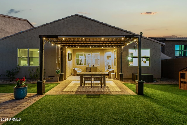 back house at dusk with a patio, cooling unit, a pergola, and a lawn