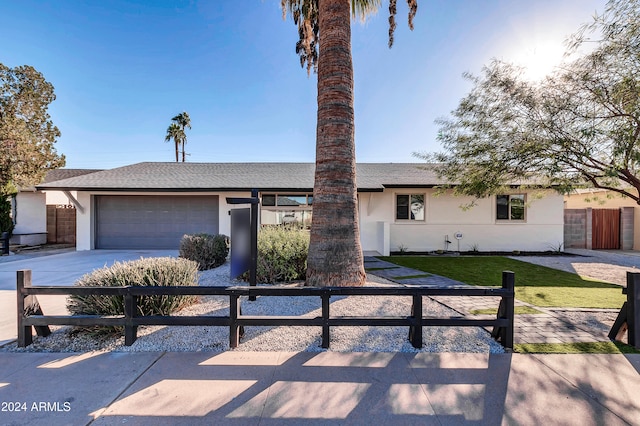 view of front of house with a garage and a front yard