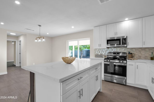 kitchen featuring a kitchen island, white cabinetry, and stainless steel appliances