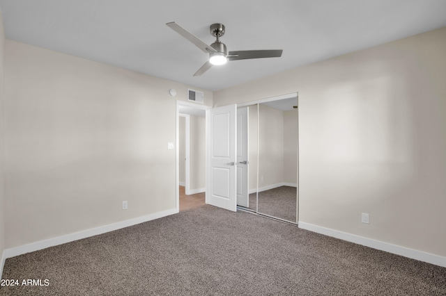 unfurnished bedroom featuring ceiling fan, a closet, and carpet floors