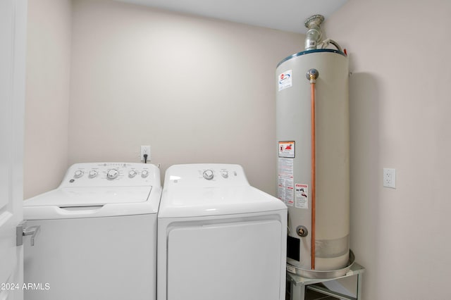 washroom featuring washing machine and dryer and gas water heater