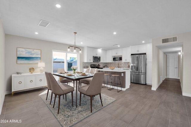 dining area featuring an inviting chandelier