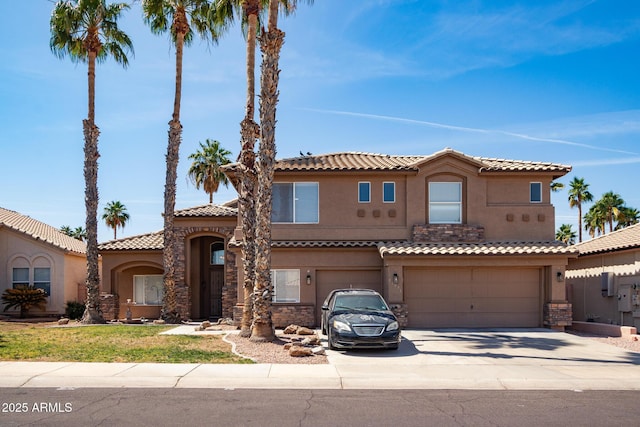 16071 W Sherman St, Goodyear, AZ 85338 - mediterranean / spanish-style house featuring a garage, stucco siding, concrete driveway, a tile roof, and stone siding