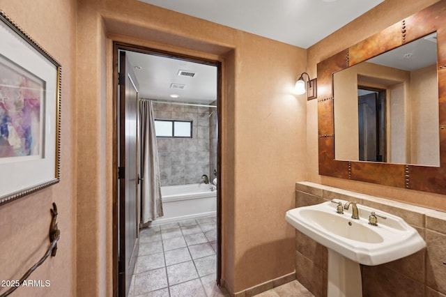 full bathroom featuring shower / bath combo and tile patterned floors