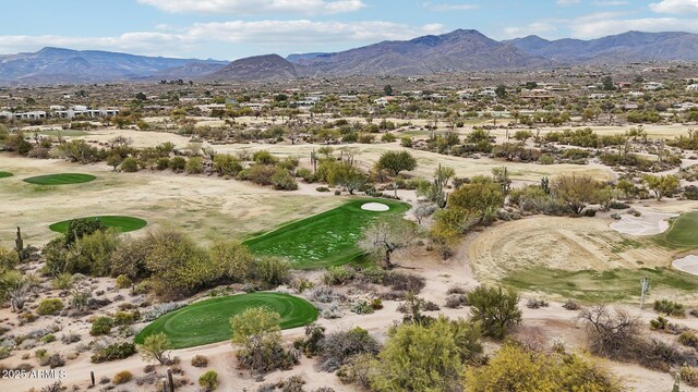 birds eye view of property with golf course view and a mountain view