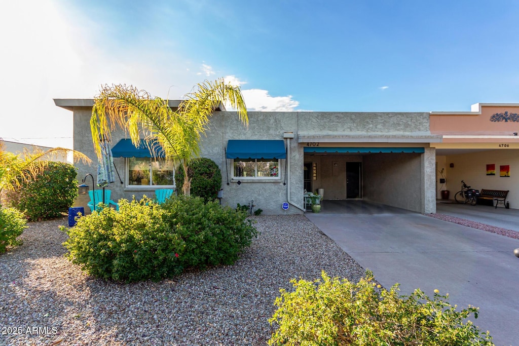 view of front of property featuring a carport