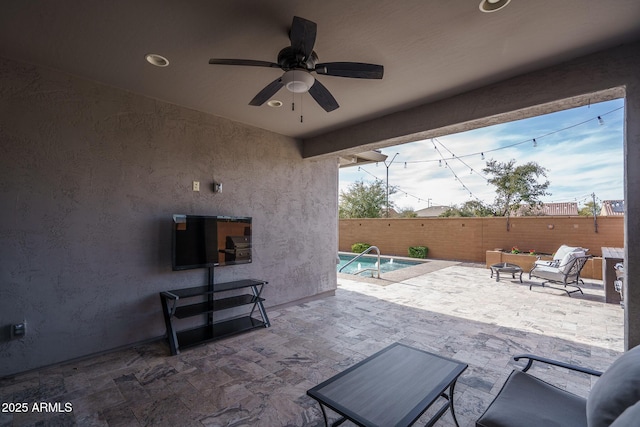 view of patio featuring a fenced in pool, an outdoor living space, and ceiling fan