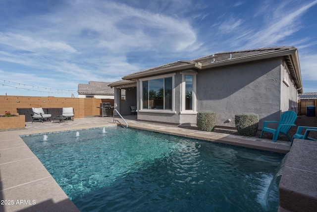 back of property featuring a fenced in pool, a patio, and pool water feature