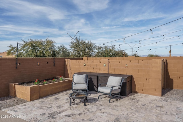 view of patio / terrace featuring a hot tub and a fire pit