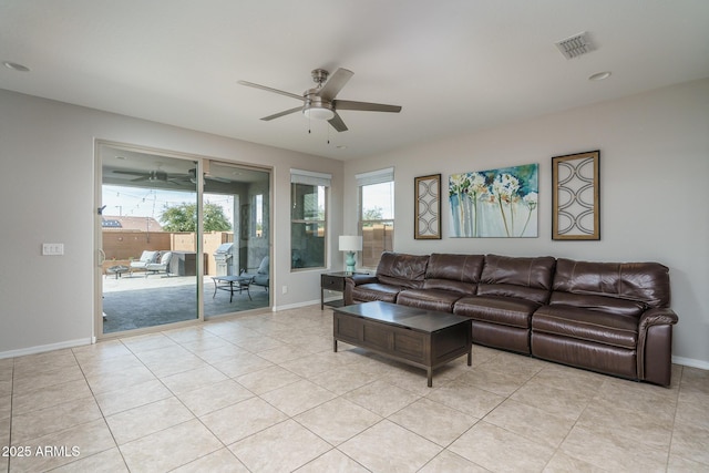 tiled living room featuring ceiling fan