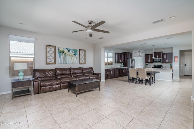 living room featuring light tile patterned flooring and ceiling fan