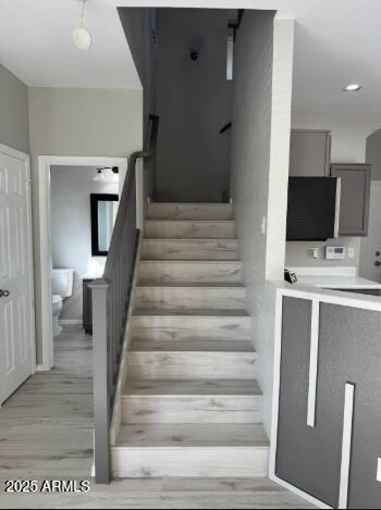 staircase featuring recessed lighting