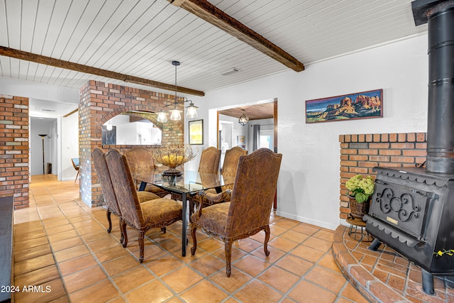 dining space featuring beamed ceiling, wood ceiling, and tile patterned flooring