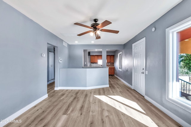 kitchen with ceiling fan, light hardwood / wood-style floors, and tasteful backsplash