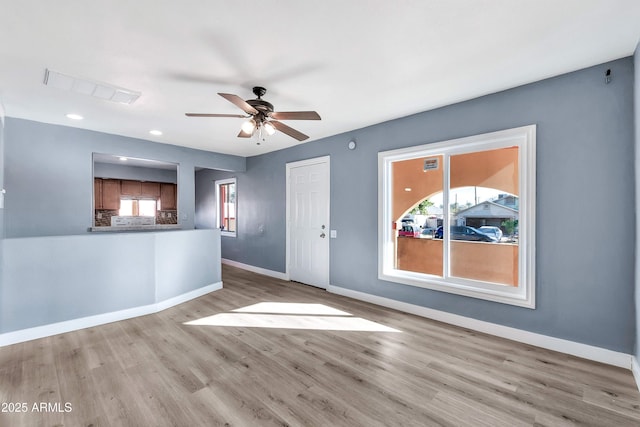 unfurnished room with light wood-type flooring and ceiling fan