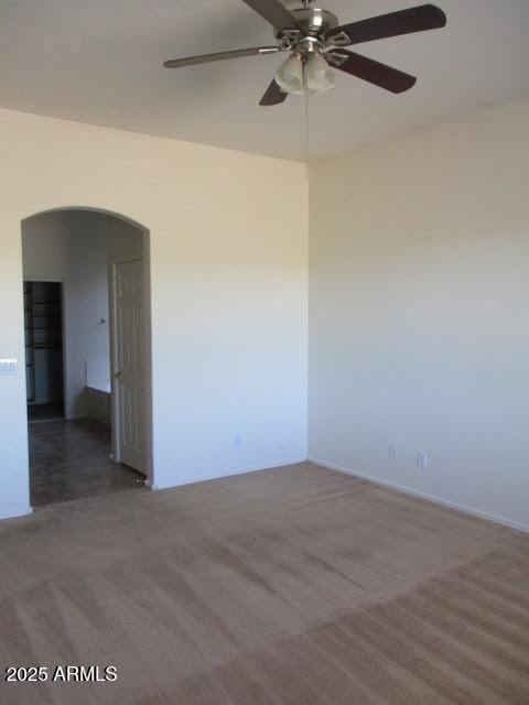 32020 N 23rd Ave, Phoenix, AZ 85085 - carpeted empty room with arched walkways and a ceiling fan