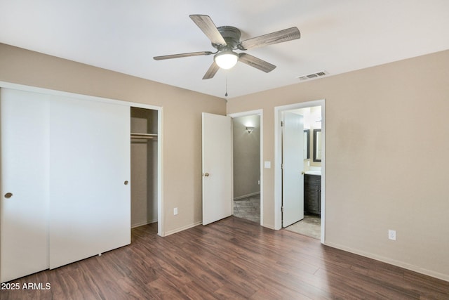 2112 E Donald Dr, Phoenix, AZ 85024 - unfurnished bedroom featuring wood finished floors, a closet, baseboards, ensuite bathroom, and a ceiling fan