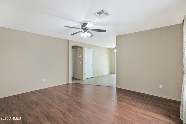 2112 E Donald Dr, Phoenix, AZ 85024 - unfurnished room featuring ceiling fan, arched walkways, wood finished floors, and baseboards