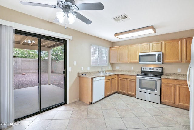 2112 E Donald Dr, Phoenix, AZ 85024 - kitchen featuring appliances with stainless steel finishes, a sink, light countertops, light tile patterned floors, and a ceiling fan