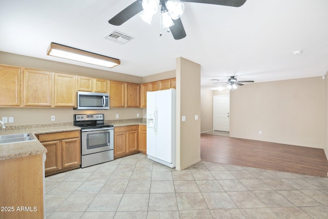 2112 E Donald Dr, Phoenix, AZ 85024 - kitchen with appliances with stainless steel finishes, a sink, a ceiling fan, and light countertops