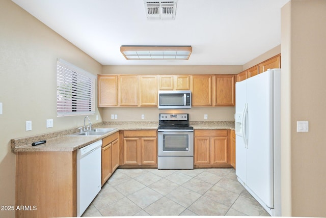 2112 E Donald Dr, Phoenix, AZ 85024 - kitchen with stainless steel appliances, a sink, light brown cabinets, light countertops, and light tile patterned floors