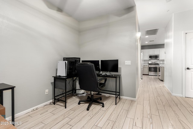 office with light wood-type flooring