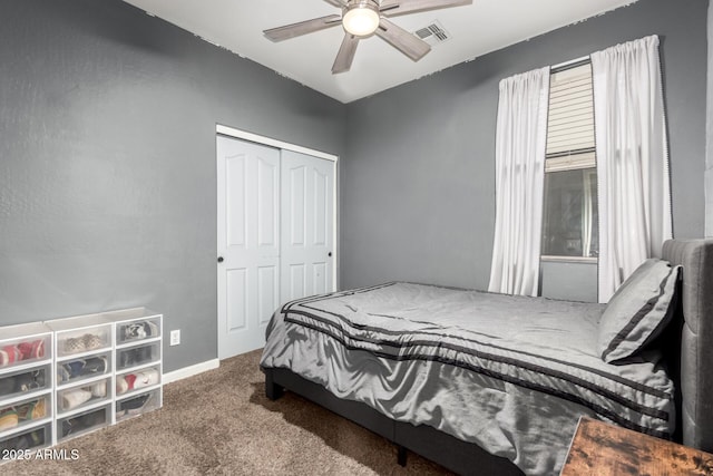 carpeted bedroom featuring ceiling fan and a closet