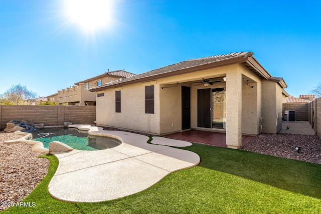 rear view of house featuring a patio area, a fenced in pool, ceiling fan, a lawn, and central air condition unit