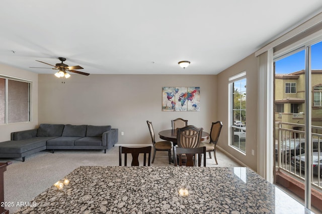 dining room featuring ceiling fan and light colored carpet