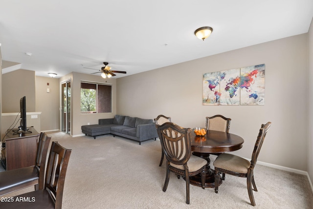 dining space with light colored carpet and ceiling fan