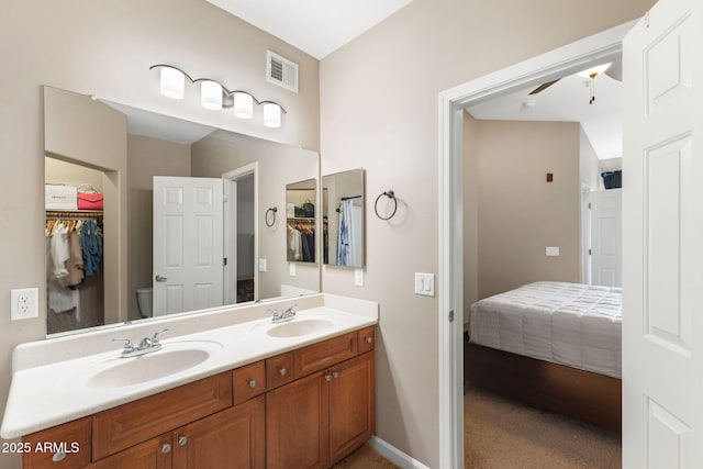 bathroom with vanity, ceiling fan, and toilet