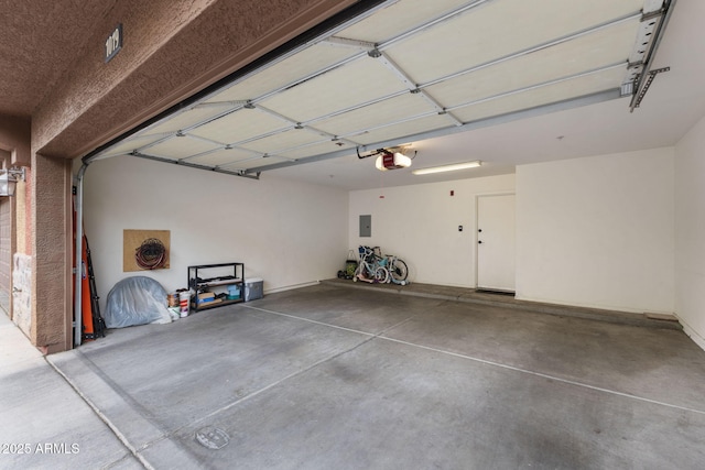 garage with a garage door opener and electric panel