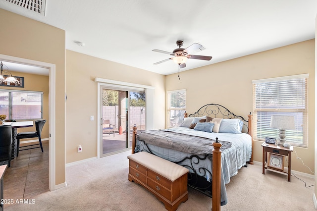 bedroom with light carpet, access to outside, visible vents, and baseboards