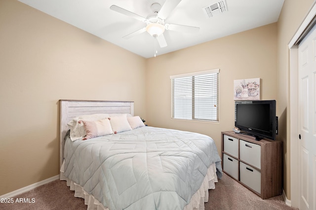 carpeted bedroom with a ceiling fan, visible vents, and baseboards