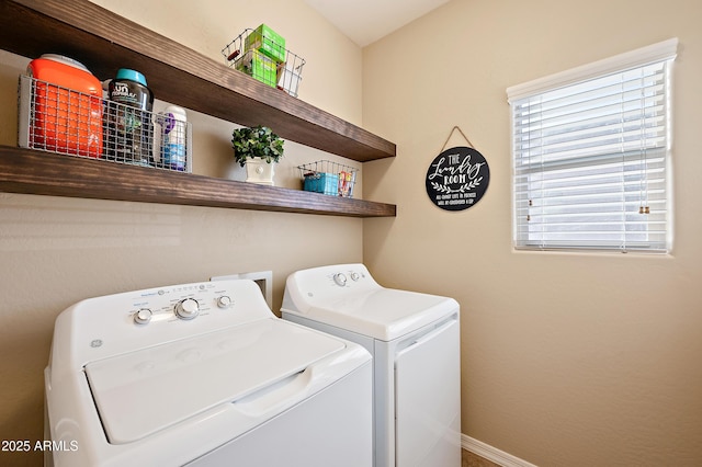 clothes washing area with laundry area, baseboards, and independent washer and dryer