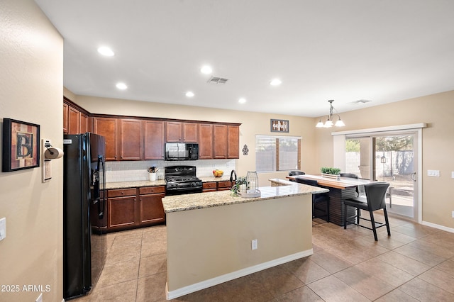 kitchen with tasteful backsplash, visible vents, light tile patterned flooring, light stone countertops, and black appliances