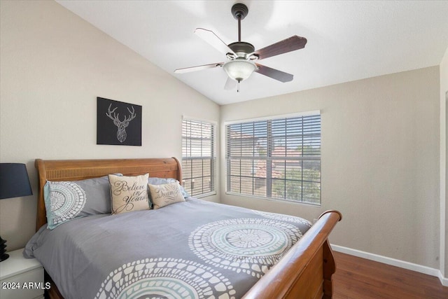 bedroom featuring dark hardwood / wood-style floors, ceiling fan, and lofted ceiling