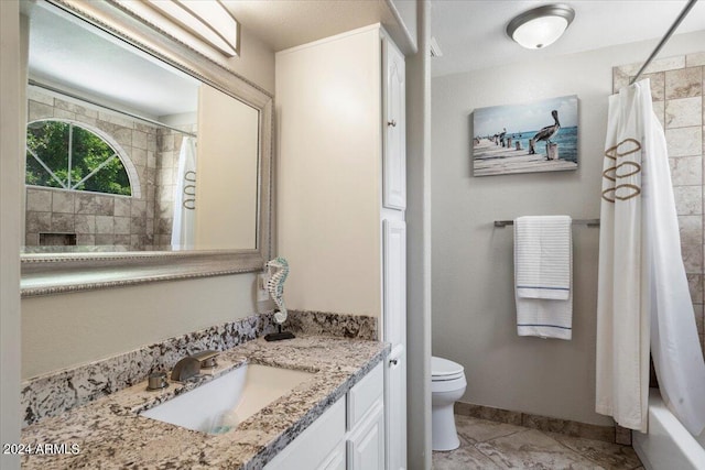 full bathroom featuring tile patterned flooring, vanity, toilet, and shower / bath combo with shower curtain