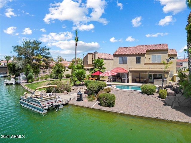 rear view of property featuring a water view and a patio